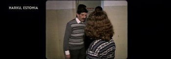 Movie still from “Flee” (2021), directed by Jonas Poher Rasmussen – A man and a woman talking to each other in a room; Medium shot, Over the shoulder angle