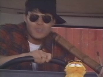 Movie still from “Crazy Hong Kong” (1993), directed by Wellson Chin – A man driving a car while holding the steering wheel of a car; Close Up shot, Low angle