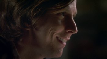 Movie still from “Crooked House” (2017), directed by Gilles Paquet-Brenner – A person's face with a smile; Close Up shot, Over the shoulder angle