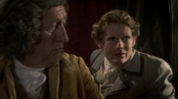 Movie still from “Crooked House” (2017), directed by Gilles Paquet-Brenner – A man and a woman are looking at each other; Close Up shot, Over the shoulder angle