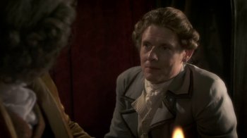 Movie still from “Crooked House” (2017), directed by Gilles Paquet-Brenner – An older man smoking a cigarette in front of a mirror; Close Up shot, Over the shoulder angle