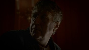 Movie still from “Crooked House” (2017), directed by Gilles Paquet-Brenner – An older man is looking into the distance; Close Up shot, Over the shoulder angle