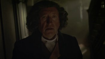 Movie still from “Crooked House” (2017), directed by Gilles Paquet-Brenner – An old man in a suit and tie; Close Up shot, Over the shoulder angle