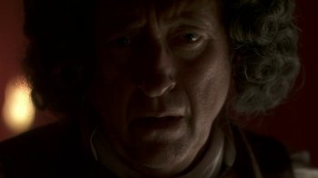 Movie still from “Crooked House” (2017), directed by Gilles Paquet-Brenner – A man's face in the dark; Close Up shot, Overhead angle