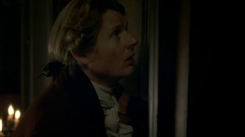 Movie still from “Crooked House” (2017), directed by Gilles Paquet-Brenner – A man in a suit looking out of a window; Close Up shot, Over the shoulder angle