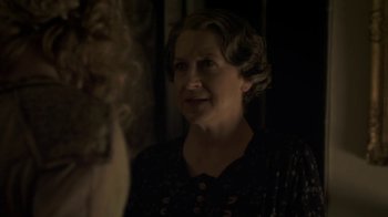 Movie still from “Crooked House” (2017), directed by Gilles Paquet-Brenner – An older woman in a black dress looking at a mirror; Close Up shot, Over the shoulder angle