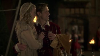 Movie still from “Crooked House” (2017), directed by Gilles Paquet-Brenner – A man and a woman standing next to each other holding wine glasses; Medium shot, Over the shoulder angle