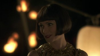 Movie still from “Crooked House” (2017), directed by Gilles Paquet-Brenner – A person wearing a necklace; Close Up shot, Over the shoulder angle