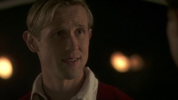 Movie still from “Crooked House” (2017), directed by Gilles Paquet-Brenner – A person wearing a red and white shirt; Close Up shot, Over the shoulder angle