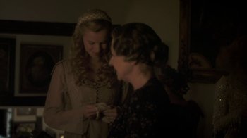 Movie still from “Crooked House” (2017), directed by Gilles Paquet-Brenner – Two women in medieval garb looking at each other; Medium shot, Over the shoulder angle