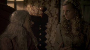 Movie still from “Crooked House” (2017), directed by Gilles Paquet-Brenner – Two women are sitting in a room talking to each other; Close Up shot, Over the shoulder angle