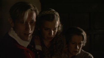 Movie still from “Crooked House” (2017), directed by Gilles Paquet-Brenner – A group of people standing next to each other in the dark; Close Up shot, Low angle
