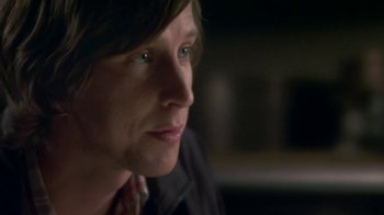 Movie still from “Crooked House” (2017), directed by Gilles Paquet-Brenner – A person looking at the camera; Close Up shot, Over the shoulder angle