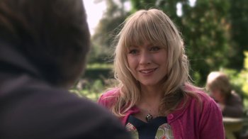 Movie still from “Crooked House” (2017), directed by Gilles Paquet-Brenner – A woman with blonde hair is talking to a man; Close Up shot, Over the shoulder angle