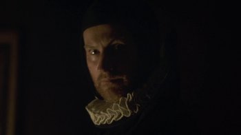 Movie still from “Crooked House” (2017), directed by Gilles Paquet-Brenner – A person wearing a hat; Close Up shot, Low angle