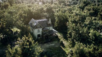 Movie still from “Curse of Chucky” (2013), directed by Don Mancini – An aerial view of a house in the middle of a forest; Extreme Wide shot, High angle