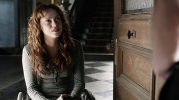 Movie still from “Curse of Chucky” (2013), directed by Don Mancini – A woman sitting in front of an open door; Medium shot, Over the shoulder angle