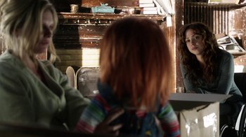 Movie still from “Curse of Chucky” (2013), directed by Don Mancini – A child looking into a mirror in front of a fireplace; Medium shot, Over the shoulder angle