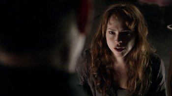 Movie still from “Curse of Chucky” (2013), directed by Don Mancini – A woman with long red curly hair stares at the camera; Close Up shot, Over the shoulder angle