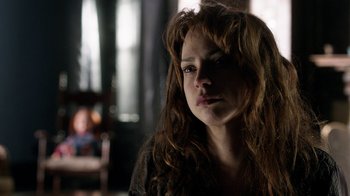 Movie still from “Curse of Chucky” (2013), directed by Don Mancini – A woman with long red hair is looking at the camera; Close Up shot, Over the shoulder angle