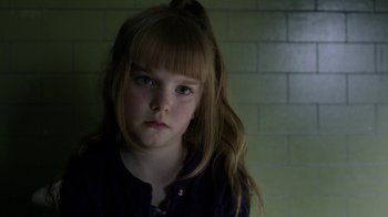Movie still from “Curse of Chucky” (2013), directed by Don Mancini – A little girl with long blonde hair and blue eyes; Close Up shot, Over the shoulder angle