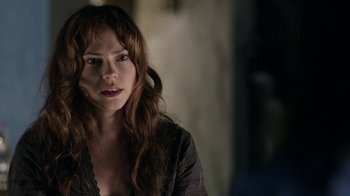 Movie still from “Curse of Chucky” (2013), directed by Don Mancini – A woman with long red hair is looking at the camera; Close Up shot, Over the shoulder angle