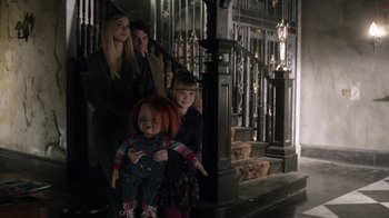 Movie still from “Curse of Chucky” (2013), directed by Don Mancini – A group of people standing next to each other in a room; Wide shot, High angle