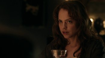 Movie still from “Curse of Chucky” (2013), directed by Don Mancini – A beautiful woman with long brown hair holding a wine glass; Close Up shot, Over the shoulder angle