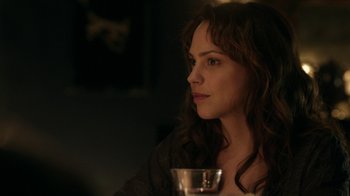 Movie still from “Curse of Chucky” (2013), directed by Don Mancini – A woman sitting at a table with a glass of wine in front of her; Close Up shot, Over the shoulder angle