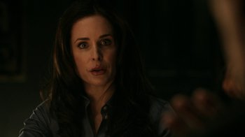 Movie still from “Curse of Chucky” (2013), directed by Don Mancini – A person with long dark hair; Close Up shot, Over the shoulder angle