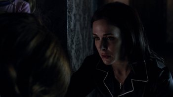 Movie still from “Curse of Chucky” (2013), directed by Don Mancini – A woman looking at a mirror in a dark room; Close Up shot, Over the shoulder angle