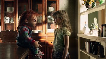 Movie still from “Curse of Chucky” (2013), directed by Don Mancini – A girl and a chucky doll talking in a room; Medium shot, Over the shoulder angle