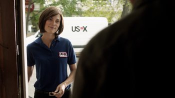 Movie still from “Curse of Chucky” (2013), directed by Don Mancini – A woman standing in front of a man in front of a building; Medium shot, Over the shoulder angle