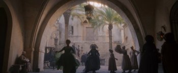 Movie still from “Cyrano” (2021), directed by Joe Wright – A group of people dressed in period clothing; Extreme Wide shot, Low angle