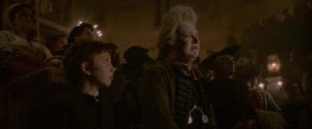 Movie still from “Cyrano” (2021), directed by Joe Wright – A man with a long white hair and a long beard; Close Up shot, Low angle