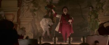 Movie still from “Cyrano” (2021), directed by Joe Wright – A man dressed in a costume and holding an umbrella; Wide shot, Low angle