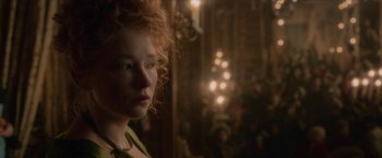 Movie still from “Cyrano” (2021), directed by Joe Wright – A person with curly red hair; Close Up shot, Over the shoulder angle
