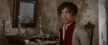 Movie still from “Cyrano” (2021), directed by Joe Wright – A man in a red and white shirt is standing in front of a mirror; Close Up shot, Over the shoulder angle