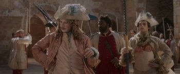 Movie still from “Cyrano” (2021), directed by Joe Wright – A man and woman dressed in period costumes; Medium shot, Over the shoulder angle