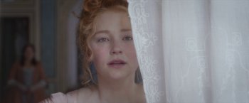 Movie still from “Cyrano” (2021), directed by Joe Wright – A young girl looking out of a window; Close Up shot, Over the shoulder angle