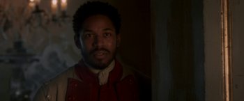 Movie still from “Cyrano” (2021), directed by Joe Wright – A person wearing a red jacket; Close Up shot, Over the shoulder angle