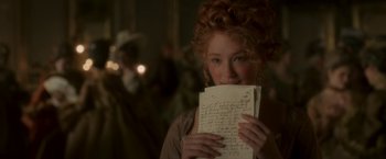 Movie still from “Cyrano” (2021), directed by Joe Wright – A woman holding a letter in front of her face; Close Up shot, Over the shoulder angle