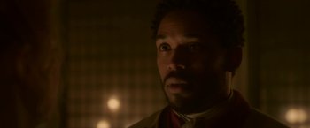 Movie still from “Cyrano” (2021), directed by Joe Wright – A person with a beard looking at the camera; Close Up shot, Over the shoulder angle