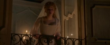 Movie still from “Cyrano” (2021), directed by Joe Wright – A woman in a white dress and veil standing next to a railing; Medium shot, Low angle