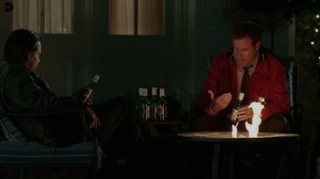 Movie still from “Daddy's Home” (2015), directed by Sean Anders – A man sitting at a table in front of a bottle of wine; Medium shot, High angle