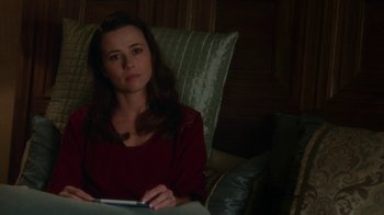 Movie still from “Daddy's Home” (2015), directed by Sean Anders – A woman sitting in a chair with a book in her lap; Close Up shot, High angle