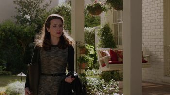 Movie still from “Daddy's Home” (2015), directed by Sean Anders – A woman standing in front of a porch holding a purse; Medium shot, Over the shoulder angle