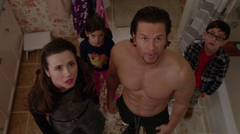 Movie still from “Daddy's Home” (2015), directed by Sean Anders – A man and a woman standing next to a little girl; Medium shot, Overhead angle