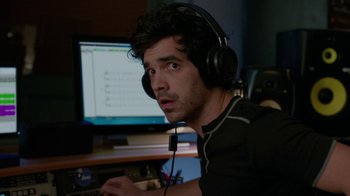Movie still from “Daddy's Home” (2015), directed by Sean Anders – A man with headphones on looking at the computer screen; Close Up shot, Over the shoulder angle