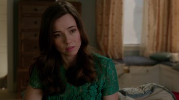 Movie still from “Daddy's Home” (2015), directed by Sean Anders – A woman in a green dress sitting in front of a window; Close Up shot, Over the shoulder angle